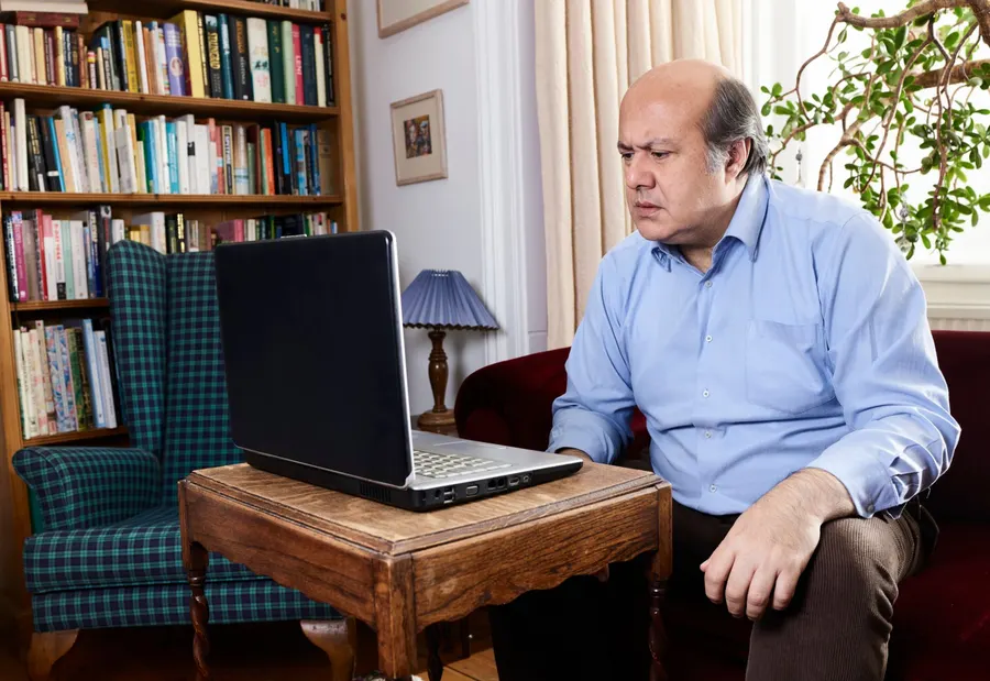 Adult working with a computer in an everyday setting