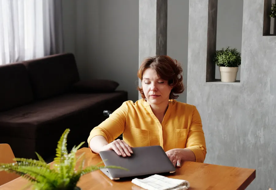 Adult working with a computer in an everyday setting